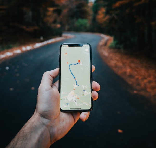 Hand holding phone with uk map app open