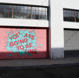 positive graffiti written on garage wall 