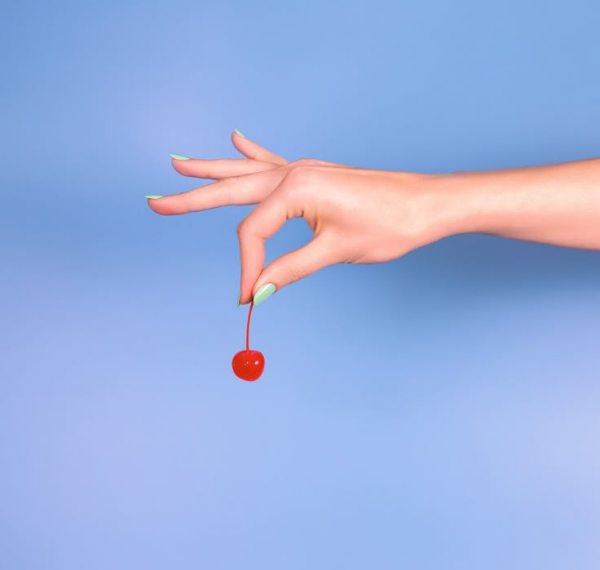 Hand holding a cherry